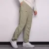 Pánské jednobarevné tkané ležérní kalhoty s rovnými nohavicemi Converse světle šedé zelené